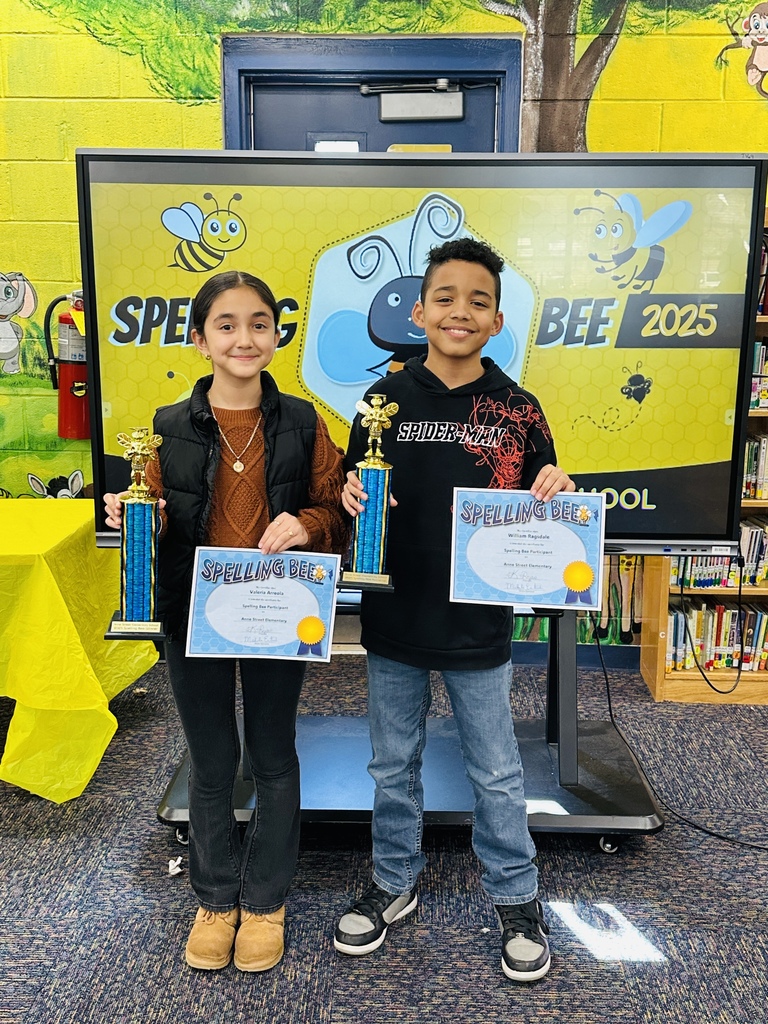 2 students holding trophies