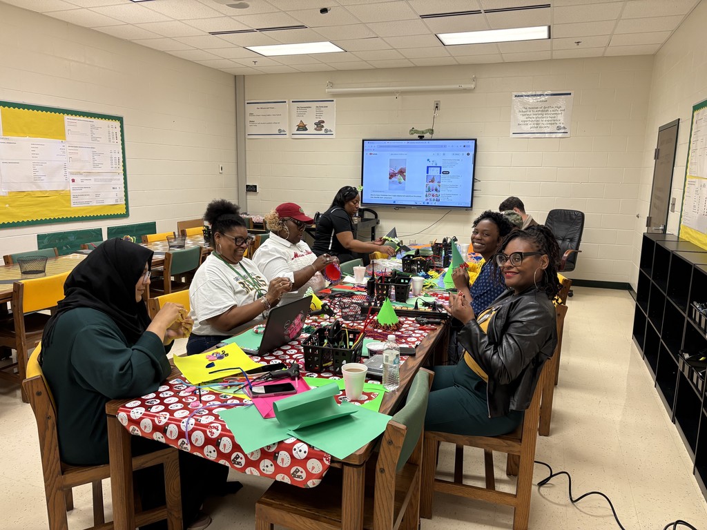 Teachers seated around a craft table