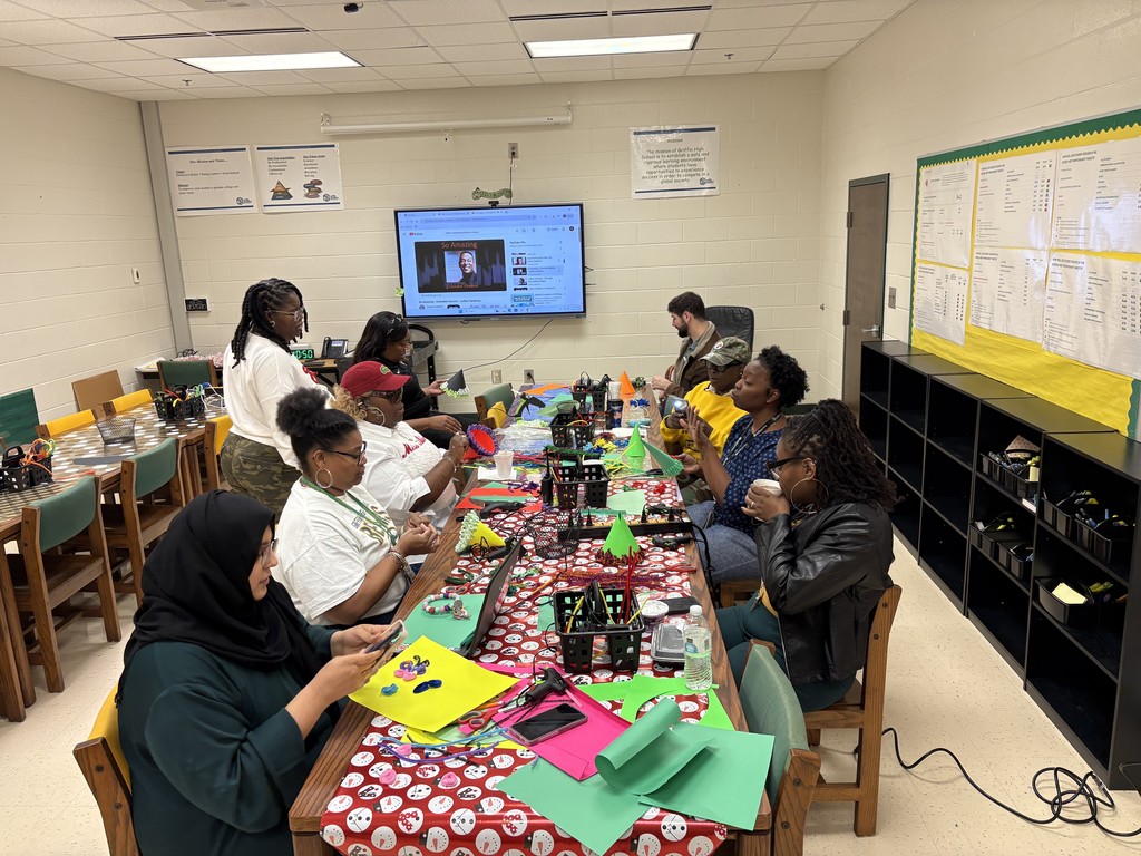 Teachers seated around a craft table