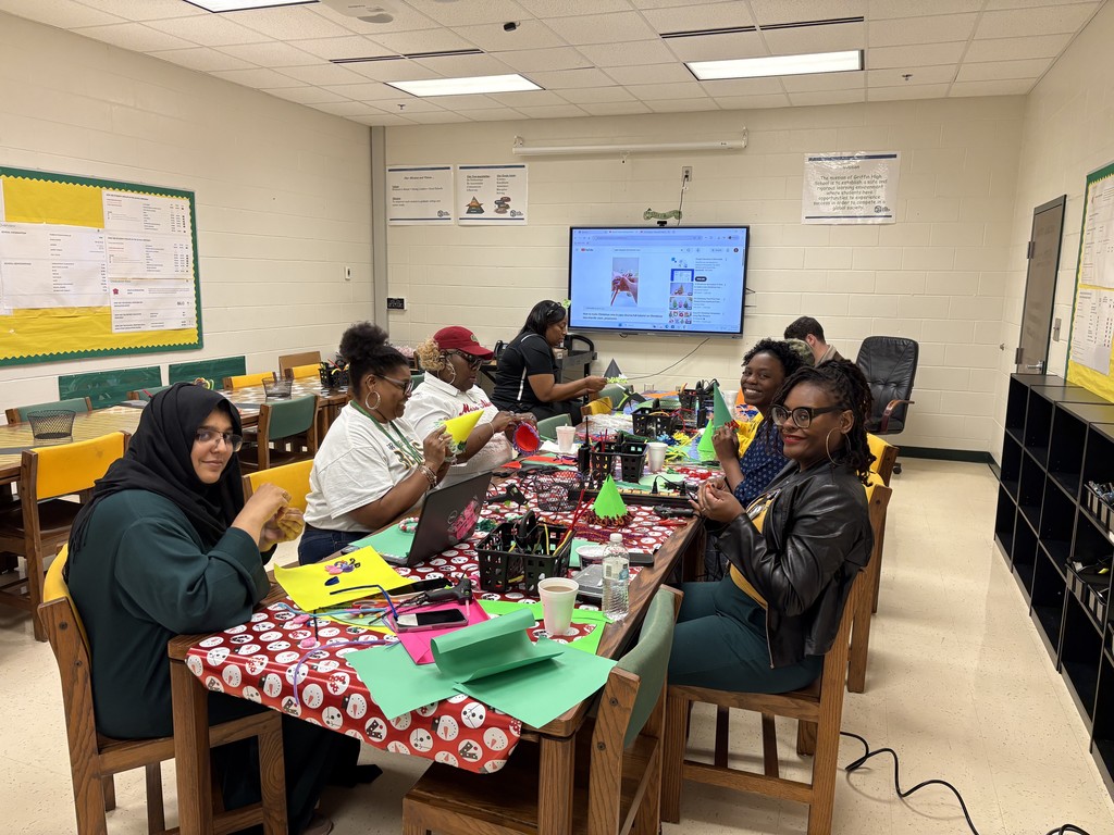 Teachers seated around a craft table