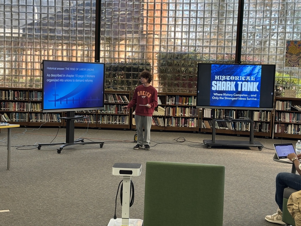 A student presents their pitch for historical shark tank
