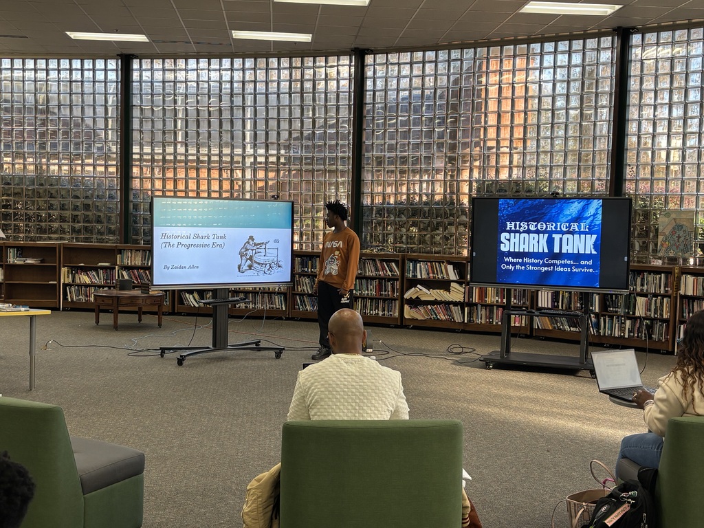 A student presents their pitch for historical shark tank