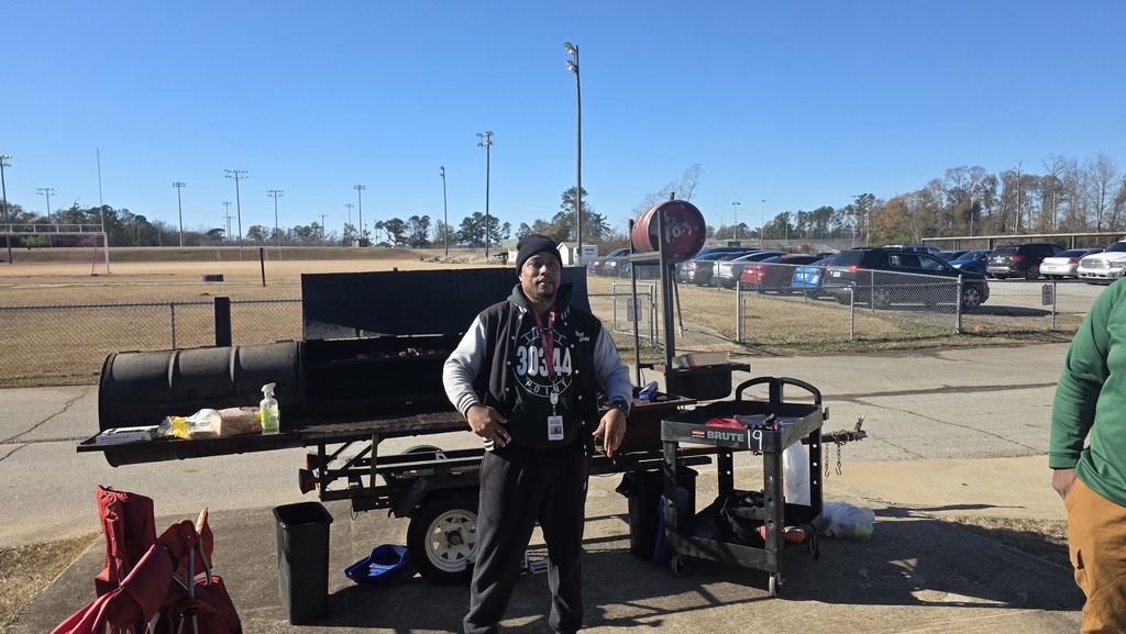 Mr. Smith of Blowin Smoke Barbecue teaches students about the smoker