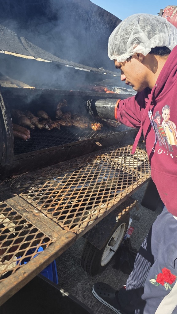 A student tends to smoking meat