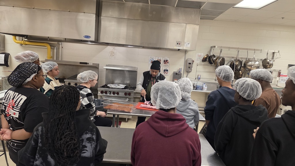 Students prepare meat for smoking