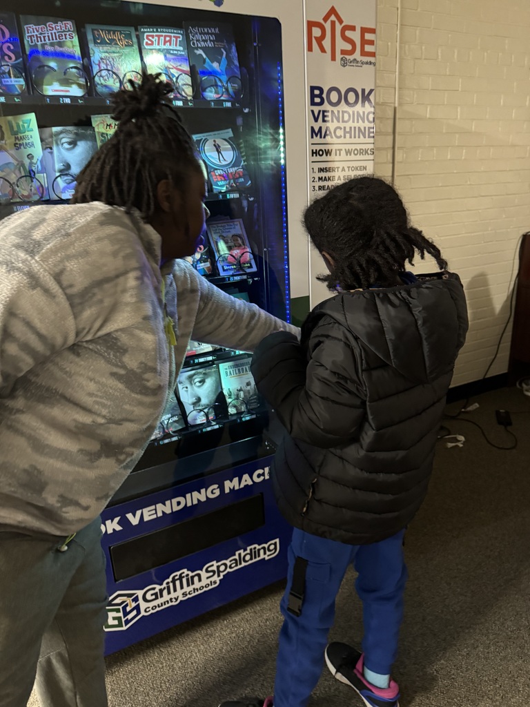 child at book vending machine