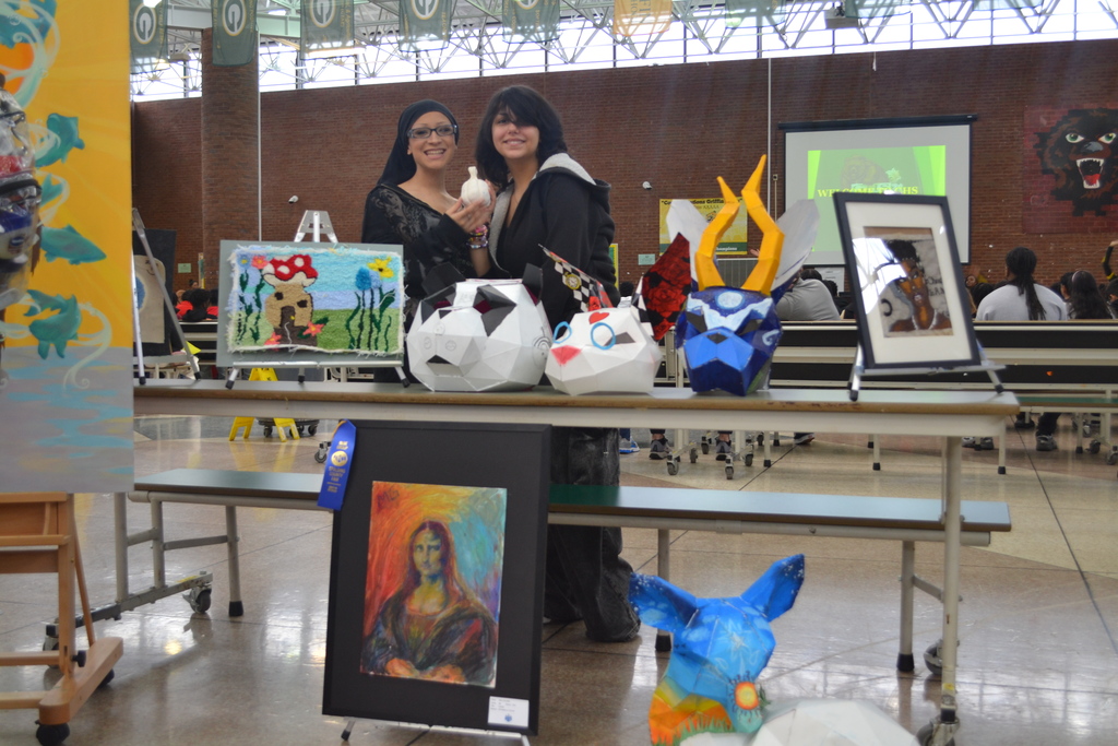 Students in the art club show off their work