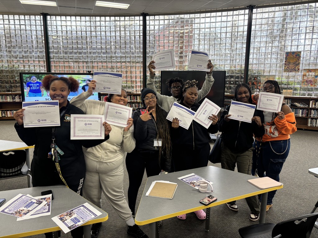 GHS students holding up their acceptance letters to Paine College