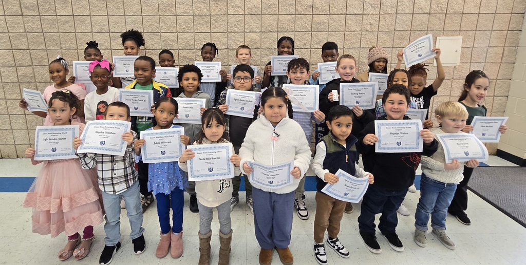 students standing holding certificates