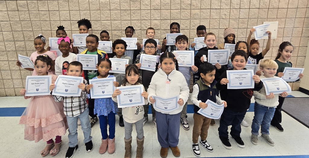 students standing holding certificates
