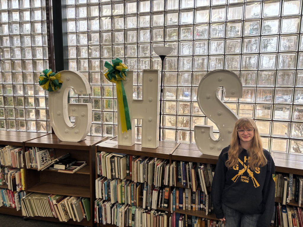Karissa stands in front of GHS banner in the Media Center