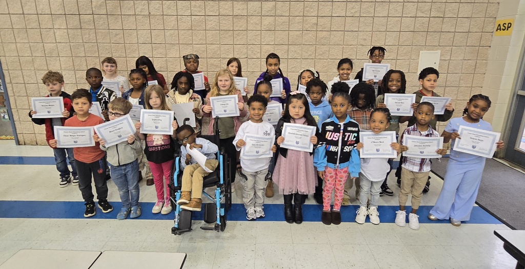 group of kids in lines holding certificate
