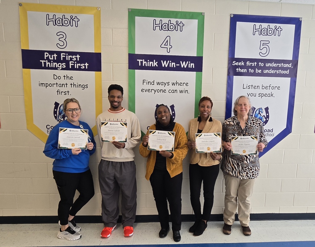 staff members in hall with certificates