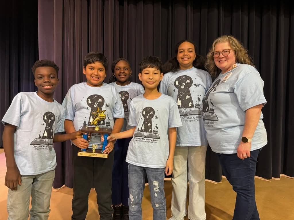 team with trophy in matching shirts 