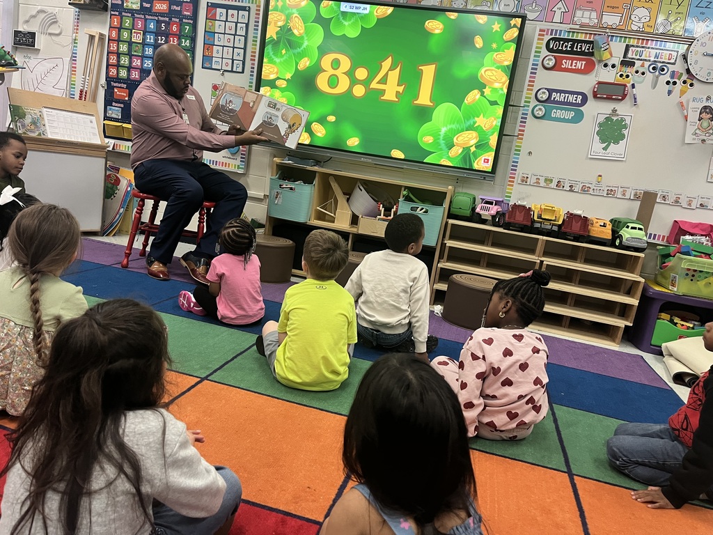 man reading to class of students