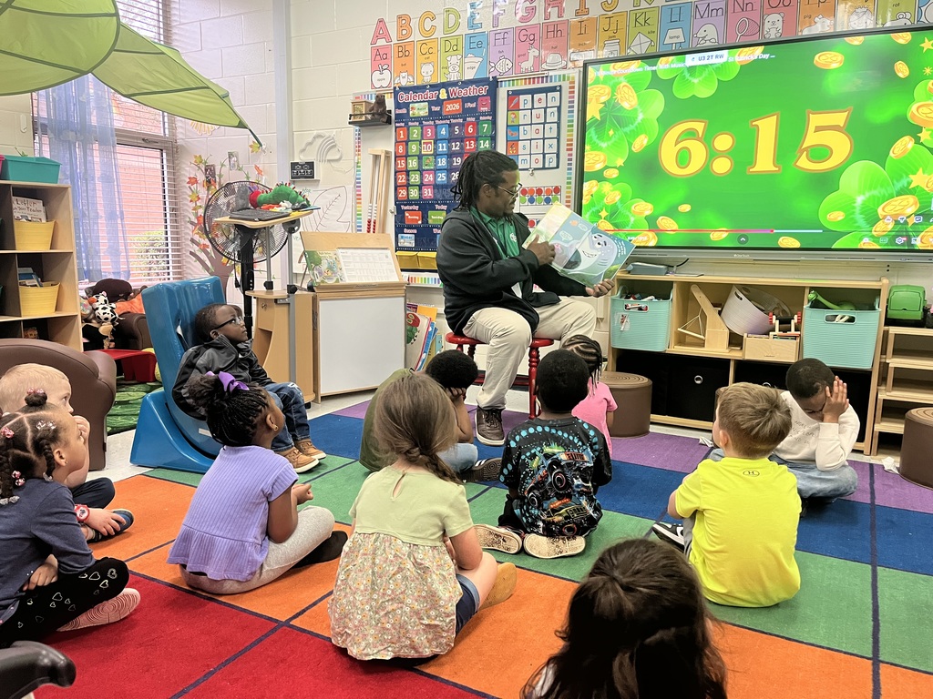 man reading to class of students