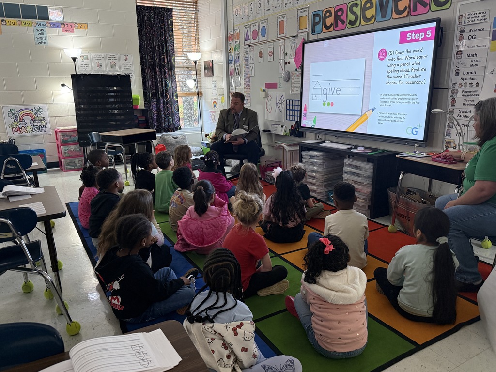 man reading to class of students