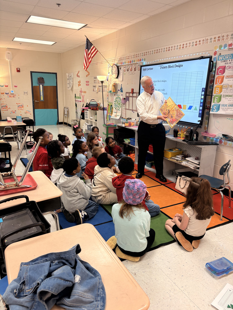 man reading to class of students