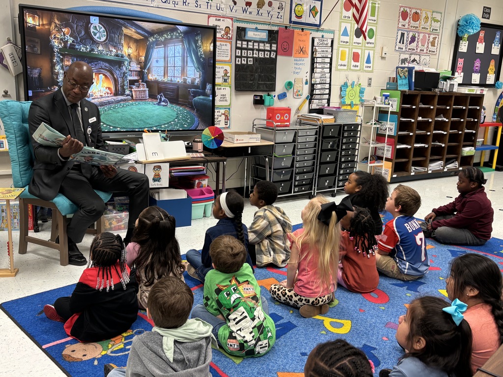 man reading to class of students