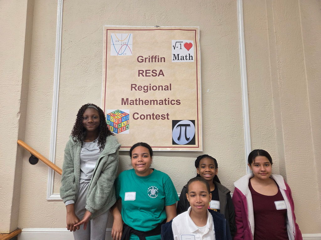 students in front of sign reading,  "Griffin RESA Regional Mathematics Competition"