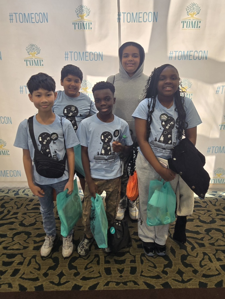 team of students in front of TomeCon backdrop