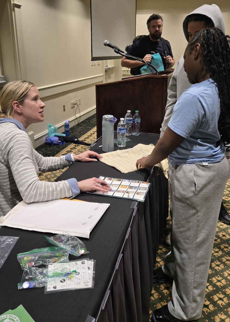 Girl getting autograph from author Jenni Walsh