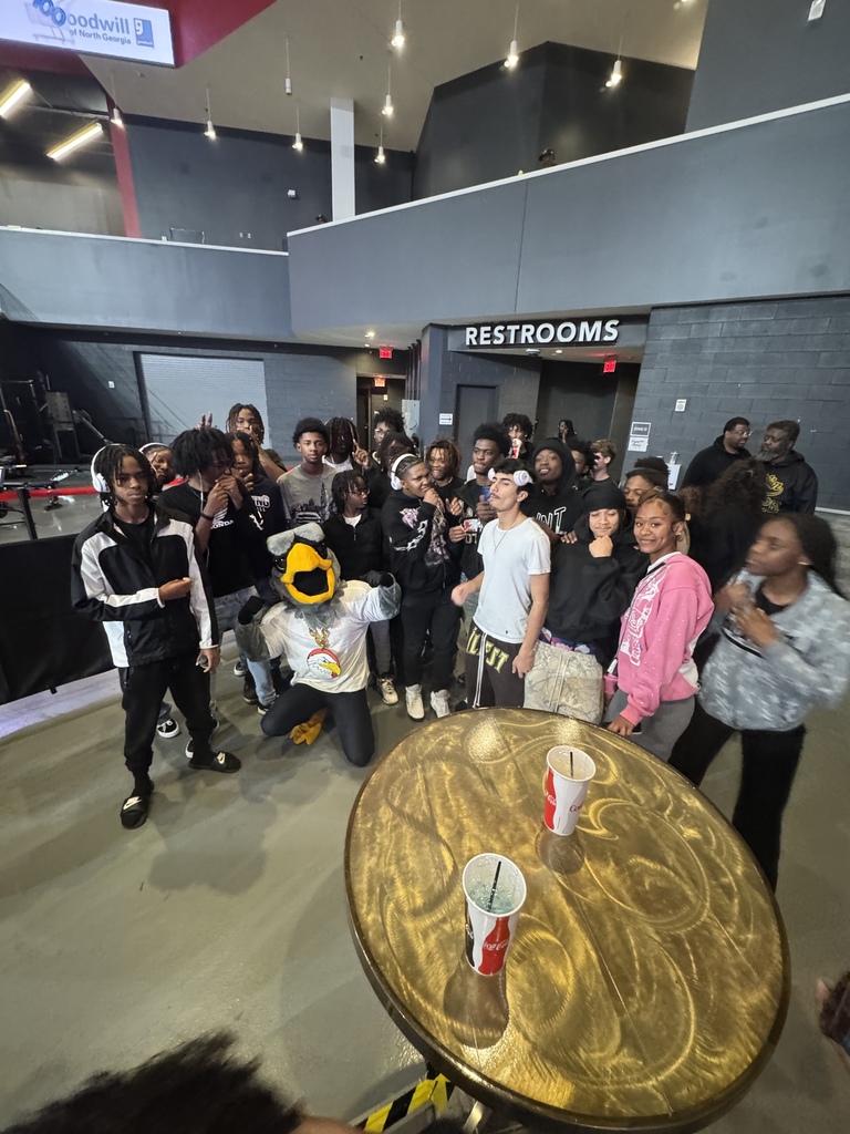 student with skyhawk mascot