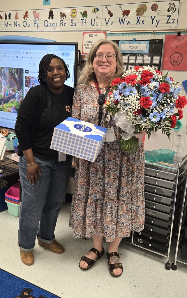 woman holding flowers beside another woman