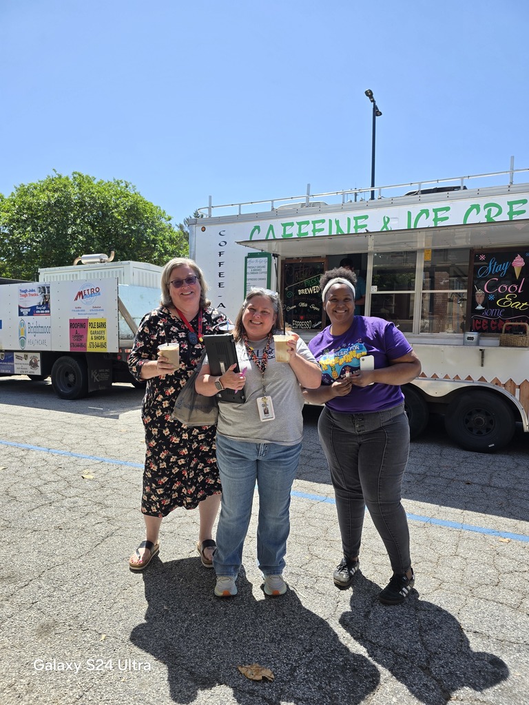 three women in front of coffee truck