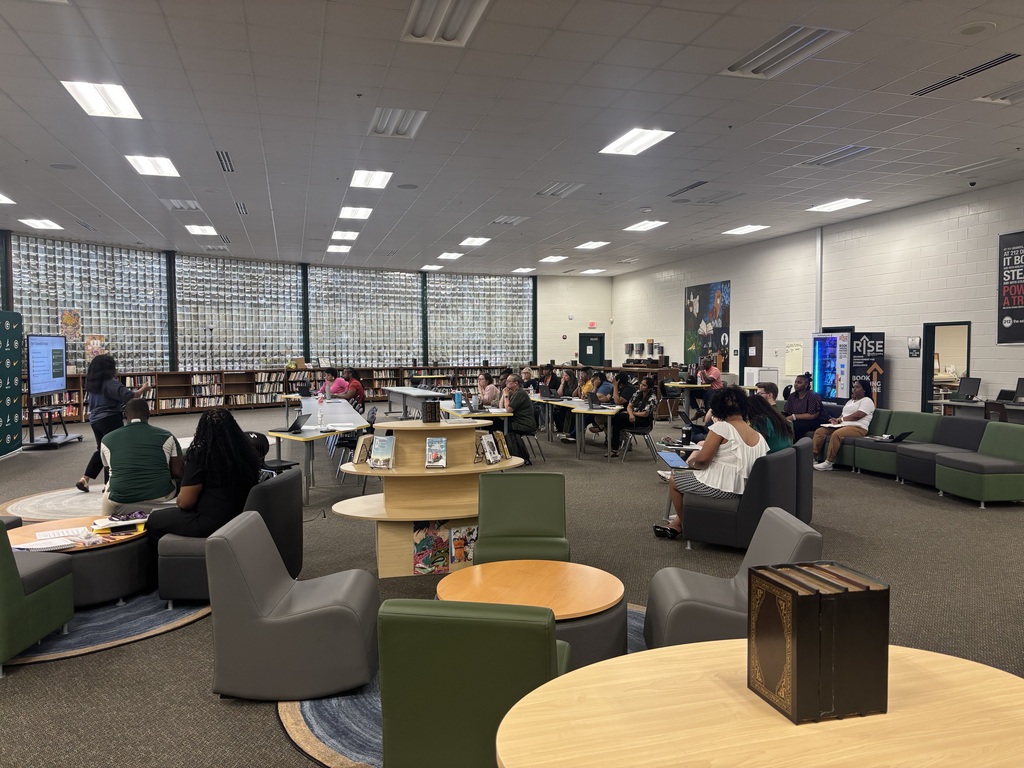 Teachers attend a meeting in the school library