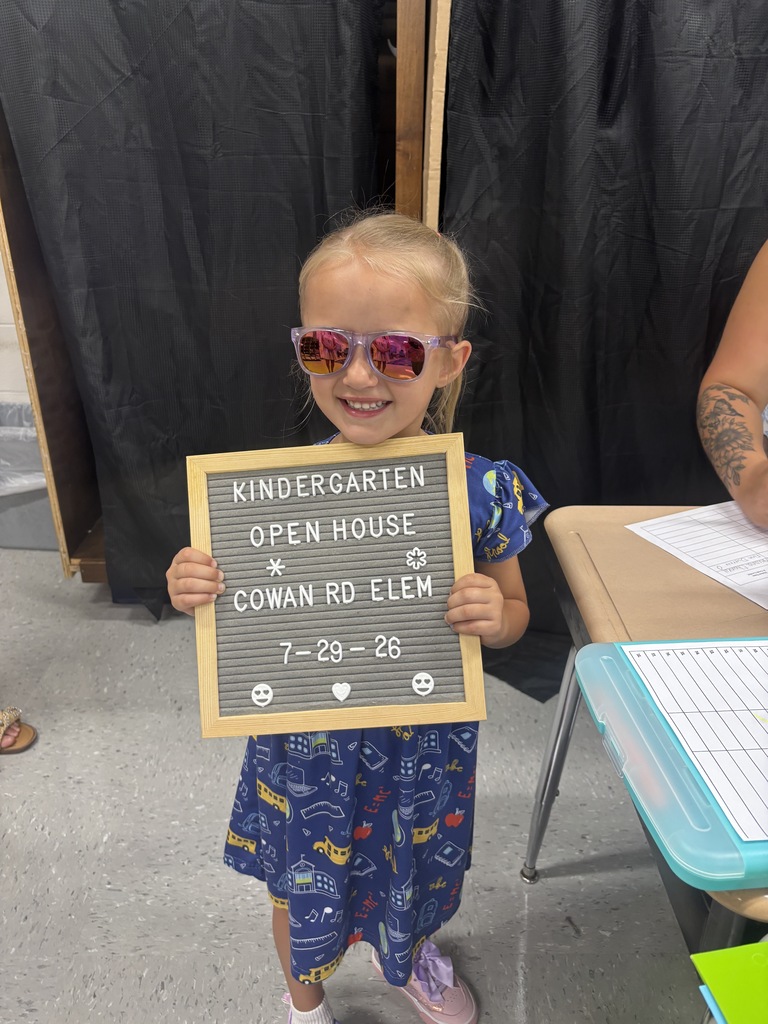 little girl with "Kindergarten Open House" letterboard