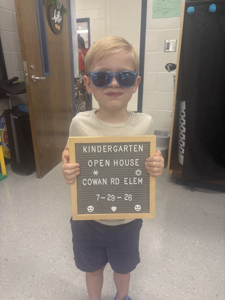 little boy with "Kindergarten Open House" letterboard