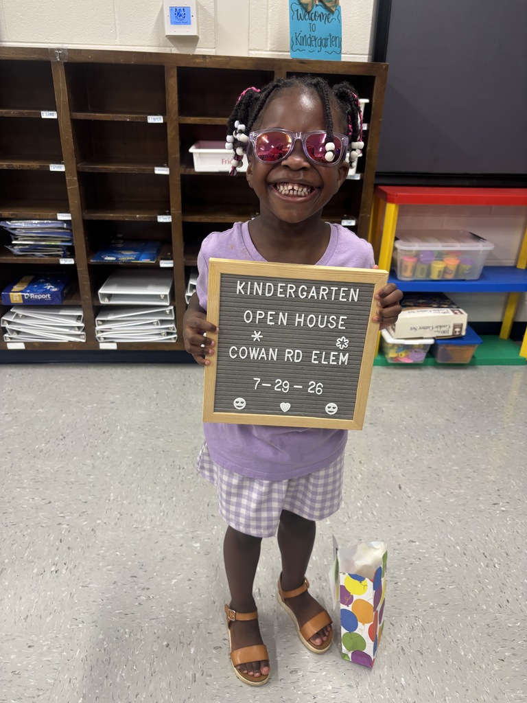 little girl with "Kindergarten Open House" letterboard