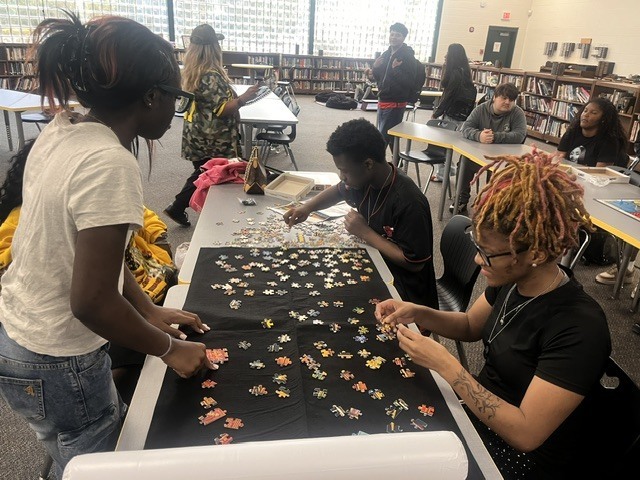 Students assemble a puzzle