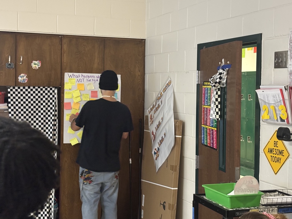 A student place his answer on the poster
