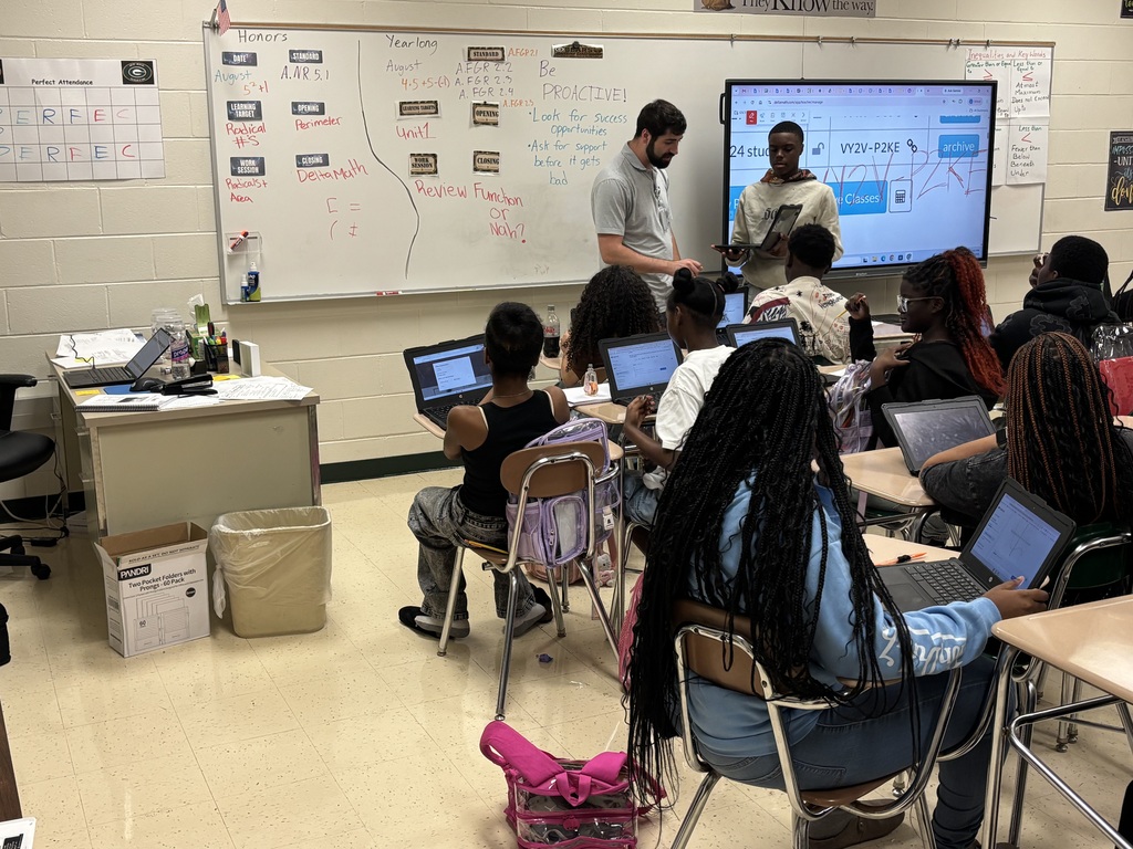 A student shows Mr. Decaeny how he solved the equation