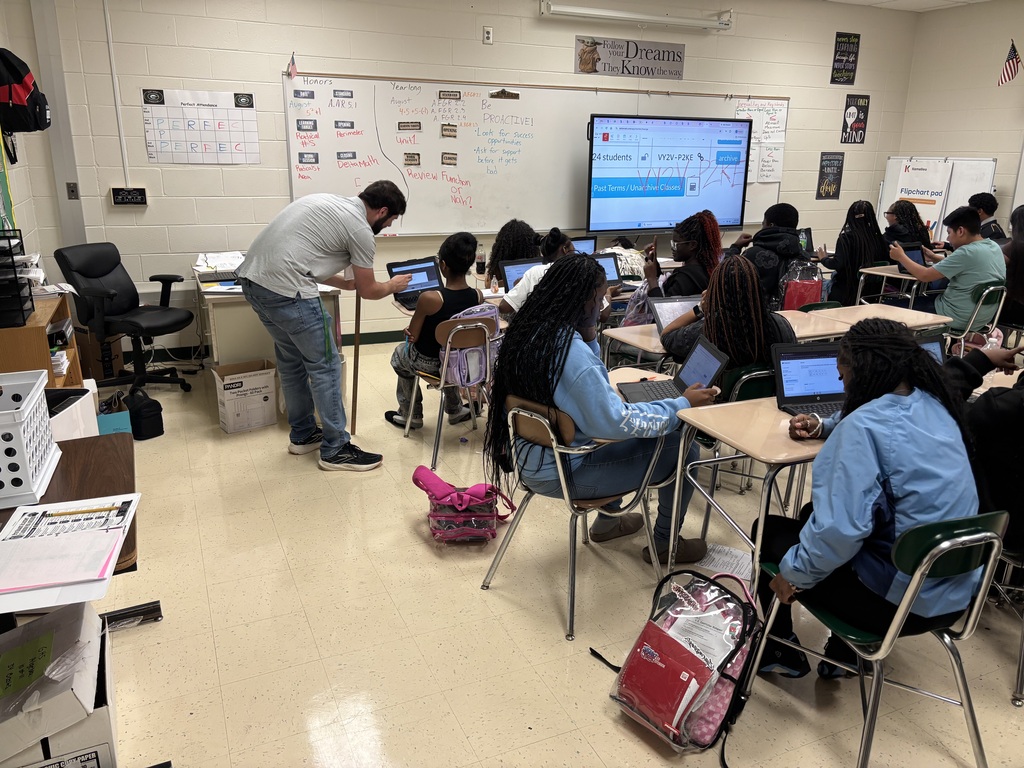 Mr. Decaeny helps a student with a problem