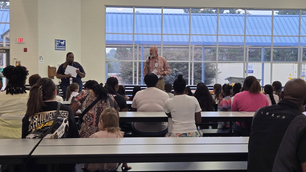 principal in cafeteria talking to parents 