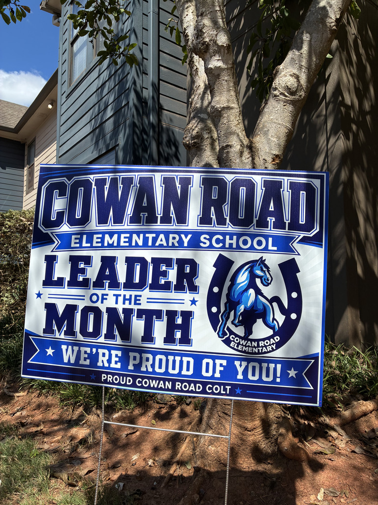 Leader of the Month sign in front of tree