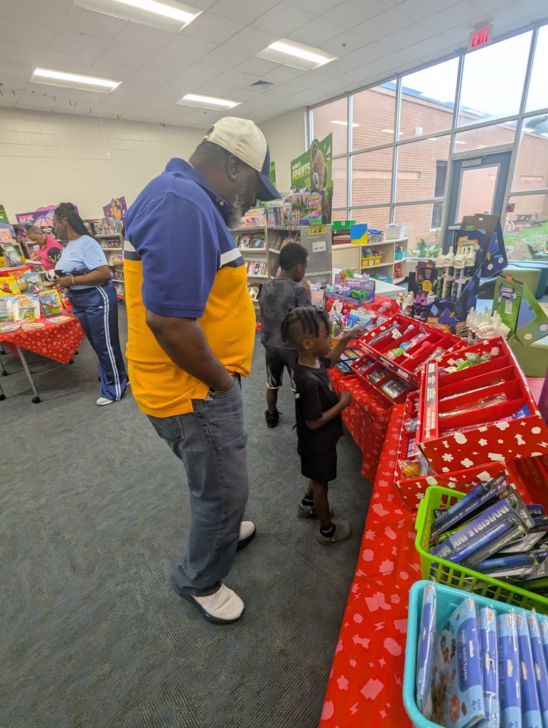 adukt and students browsing the book fair