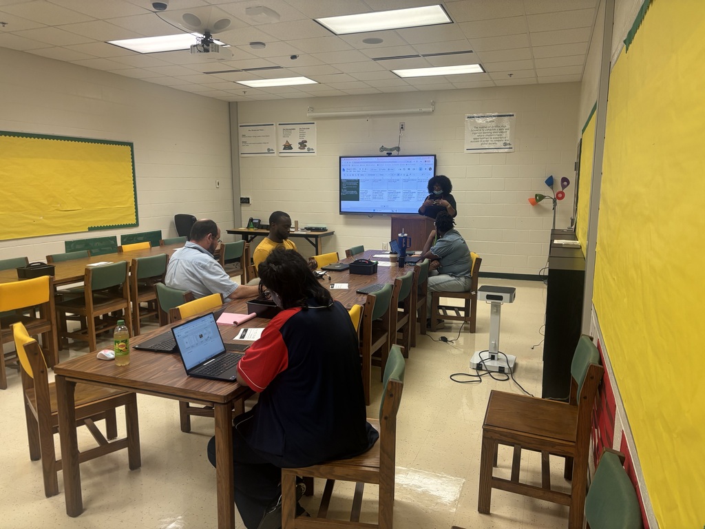 Ms. Moore presents to colleagues about her upcoming lessons this week.