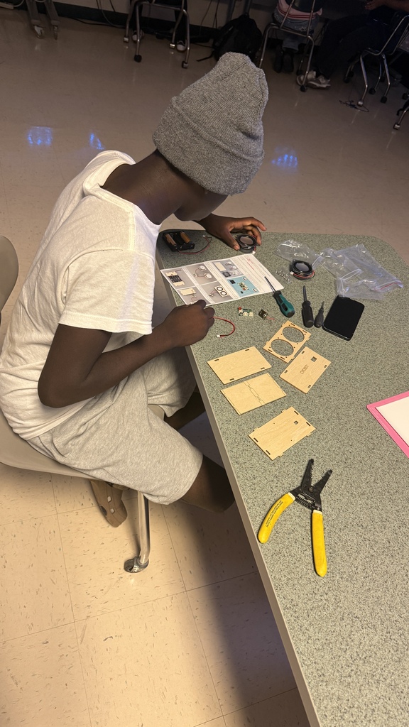A student works on building a bluetooth speaker