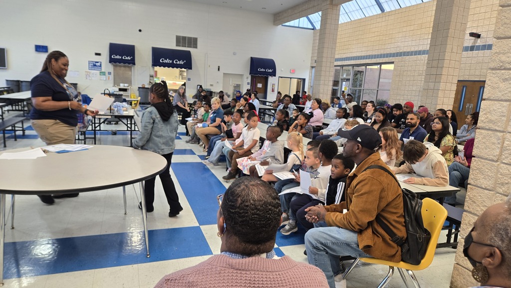 families sitting at tables in school cafeteria