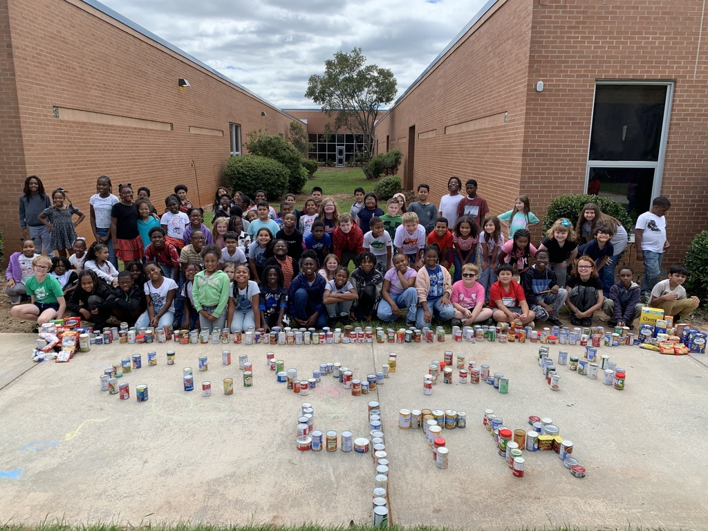 group of students with canned goods spelling "Cowan 4th"