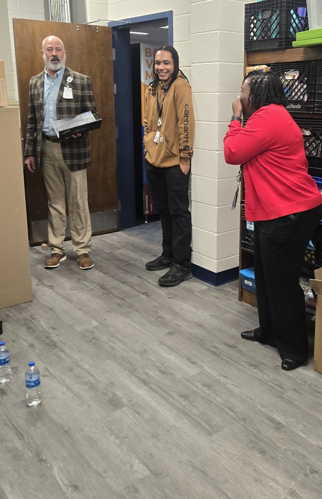 people laughing with man and water bottles on floor