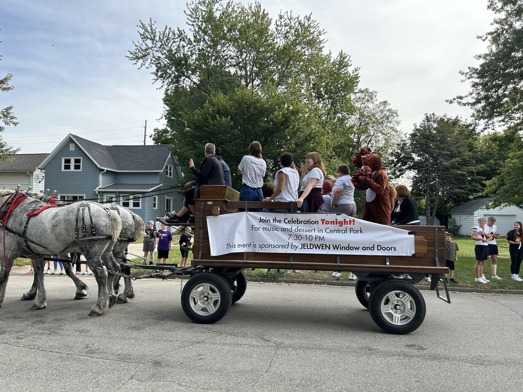 Horse and buggy with sign on side and people inside
