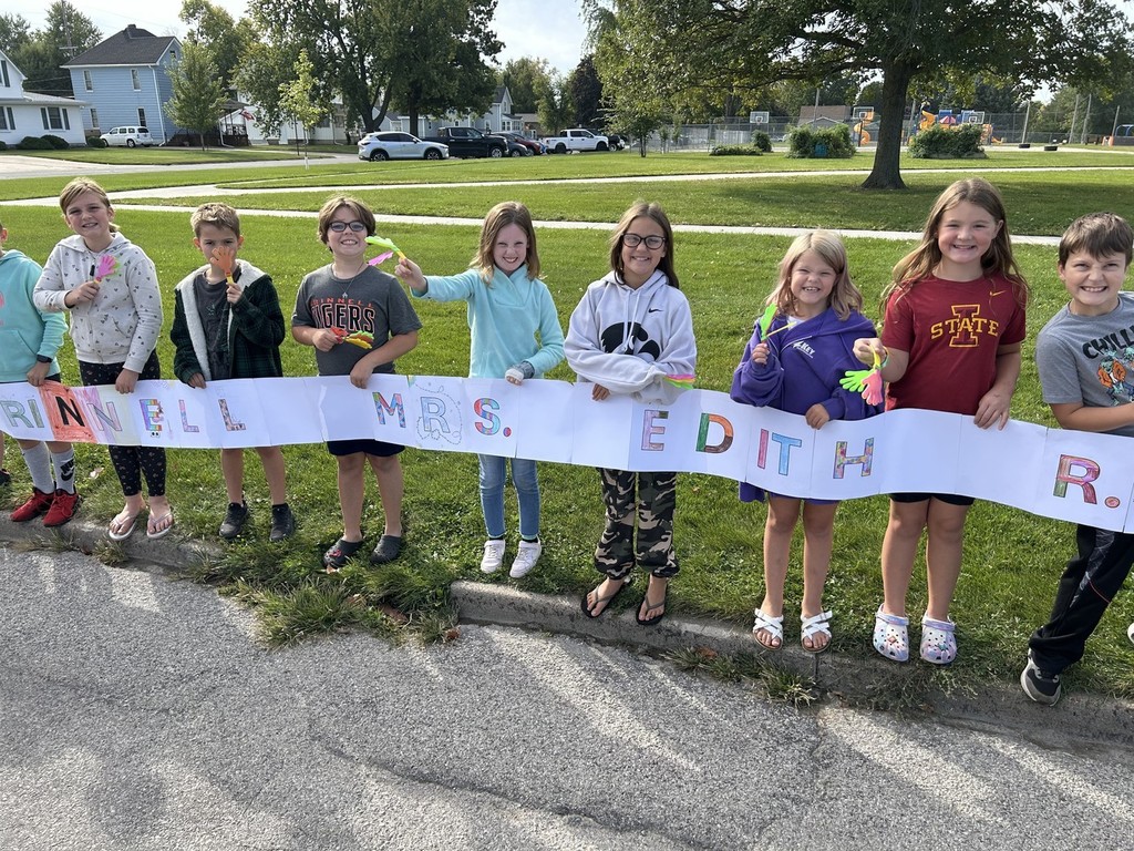 Students holding sign for parade