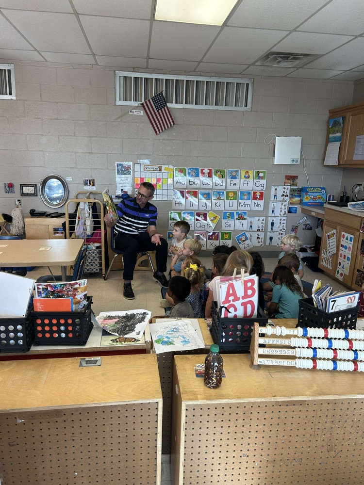The superintendent reading to the three-year-old class
