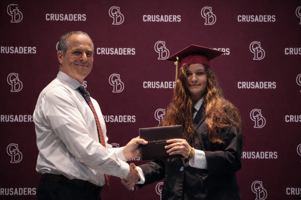 Mr. Arena hands Katie Dressel a "Diploma"
