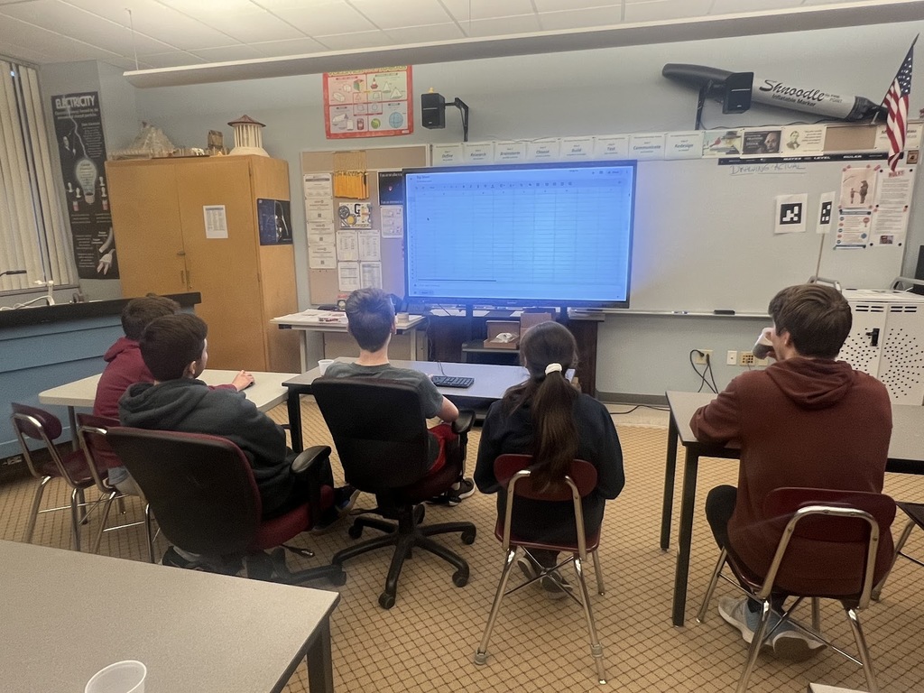 students working on a teaching panel